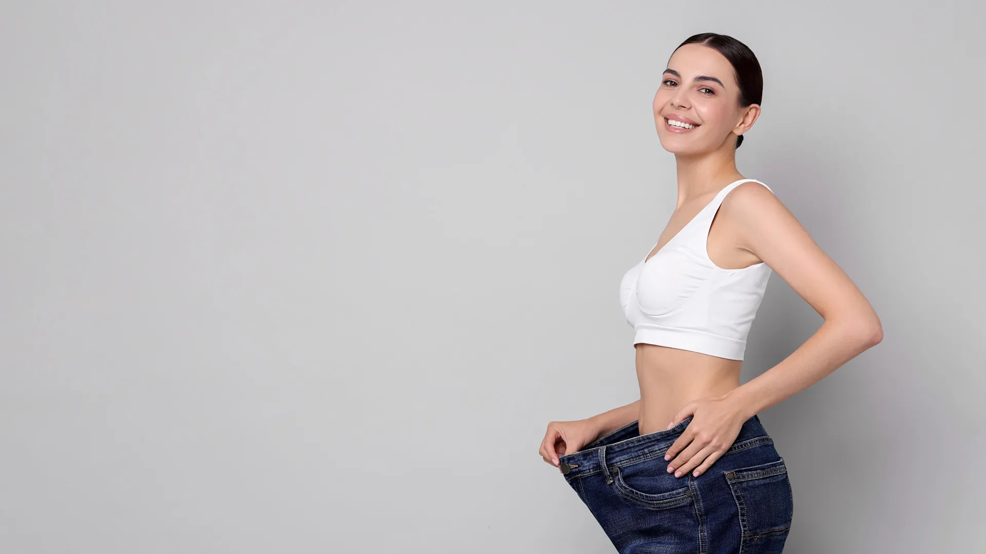 Healthcare professional measuring patient waist during medical weight loss consultation